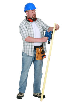 Landscape picture of carpenter sanding