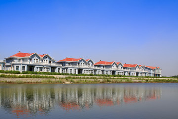 Obraz premium red roof building at water's edge