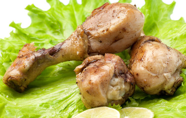 the fried chicken, lime segments on salad sheets.
