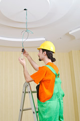 Electrician working on cabling lighting