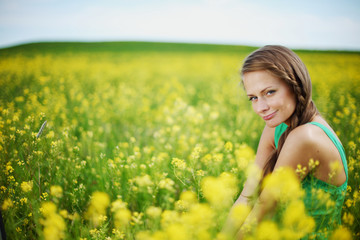 Naklejka na ściany i meble woman on oilseed field