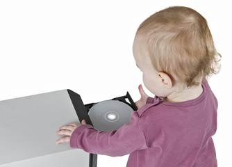 young child playing with CD