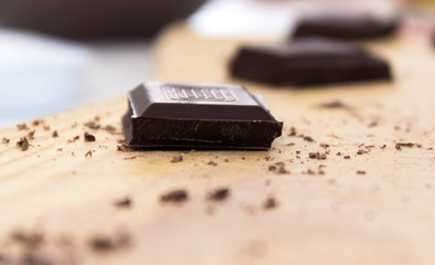 Chopped chocolate  on wooden chopping board