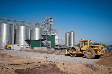 Silver Grain Silos with blue sky in background