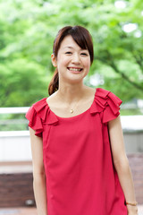 Beautiful young woman on the green. Portrait of asian woman.