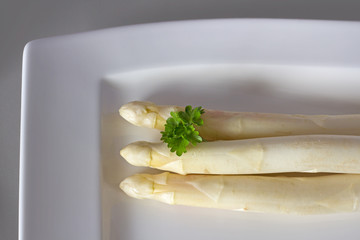 White asparagus with parsley on a plate