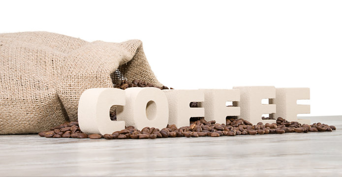 Coffee letters on vintage wood background with space