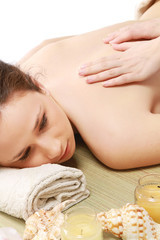 Obraz na płótnie Canvas An attractive young woman receiving a massage