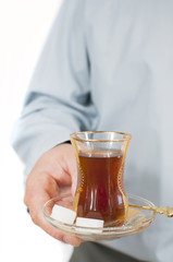 Young man serving turkish chai