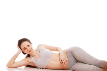 Obraz premium A sportive young woman lying on the floor
