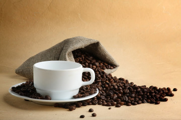 A sack of coffee beans and a cup