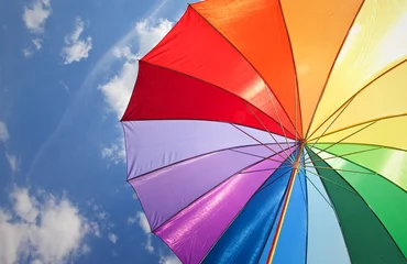 Fotobehang Rainbow umbrella on sky background © NinaMalyna