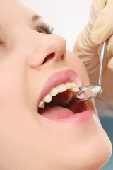 Examining patient's teeth, closeup