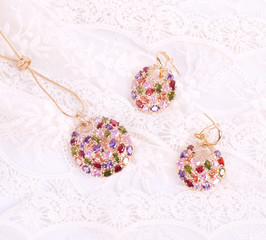 Golden jewelry on white laces background