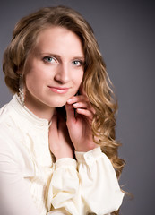 Beautiful young woman on dark background