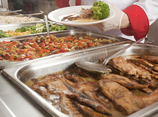 chef standing behind full lunch service station