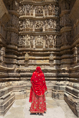 A woman in red sari, Khajuraho Temples, India.