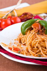 Spaghetti with tuna, cherry tomatoes and capers.