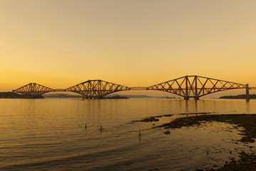 The Forth railway bridge at sunset near Edinburgh, Scotland.