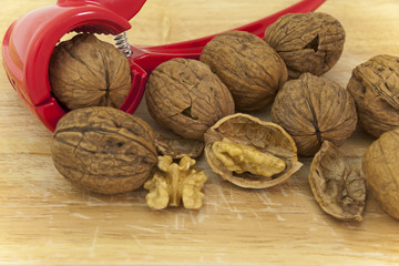 walnuts on wood background with nutcracker