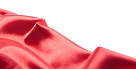 Abstract red silk or satin fabric over white