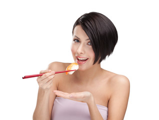 Young woman holding sushi with a chopsticks