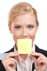 Business woman holding a yellow sticker in front of her face