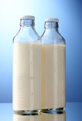 bottles of milk on blue background