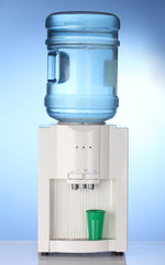 Electric water cooler on blue background