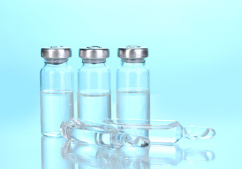 Medical ampoules on blue background