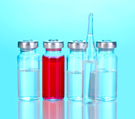 Medical ampoules on blue background