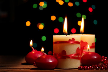 Beautiful candles on wooden table on bright background