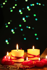 Beautiful candles on wooden table on bright background