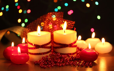 Beautiful candles and decor on wooden table on bright