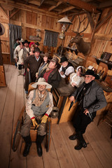 Relaxed Crowd with Guns in Saloon