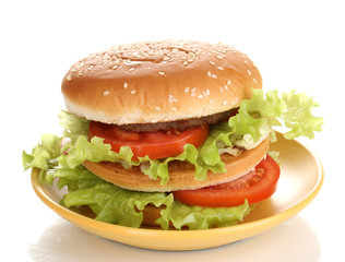 Big and tasty hamburger on plate isolated on white