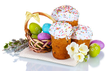 Beautiful Easter cakes, colorful eggs in basket and flowers