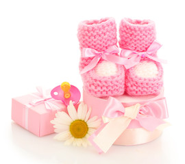 pink baby boots, pacifier, gifts and flower isolated on white