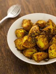 close up of a bowl of crusty baked potatoes