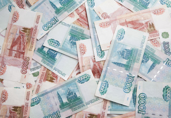 Fototapeta na wymiar Background of one and five thousand russian roubles bills