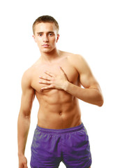 Fototapeta premium A muscular man holding his chest, isolated on white
