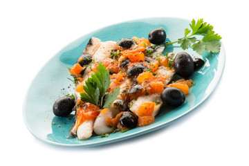 fish fillet with tomatoes balck olives and pepper