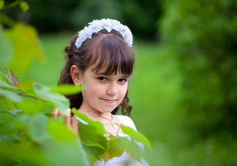 Portrait of a young girl in the park at summer