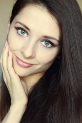Obraz premium Portrait of beautiful woman touching clean face with green eyes