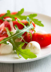 Caprese salad with arugula leaves