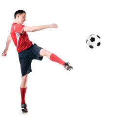 soccer player hits the ball
