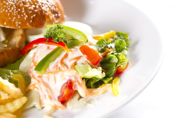salad sides, a dish of hamburger with fries and salad