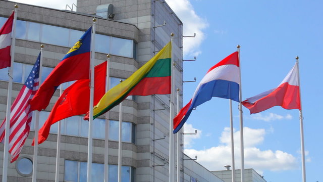 Flags of  various states on  background of modern  center