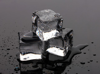 Melting ice cubes on grey background