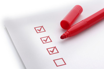 Checklist and red marker closeup